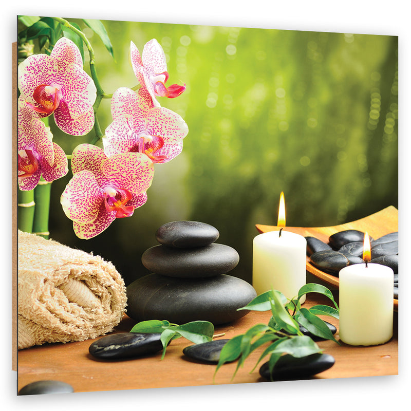 Cuadro decorativo con estampado, velas de orquídeas y piedras zen.