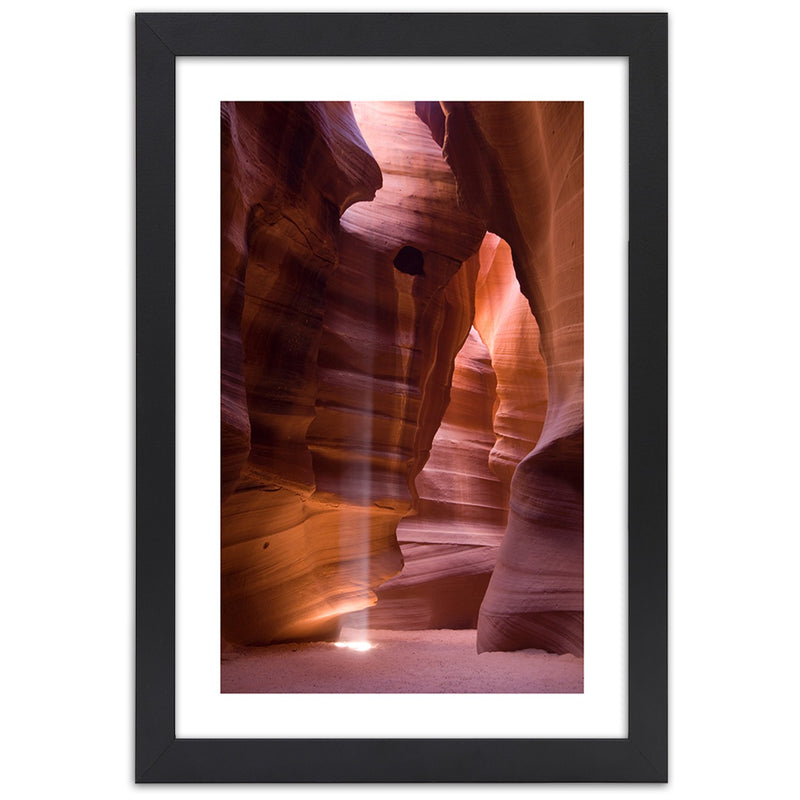 Picture in black frame, Sunrays in a cave